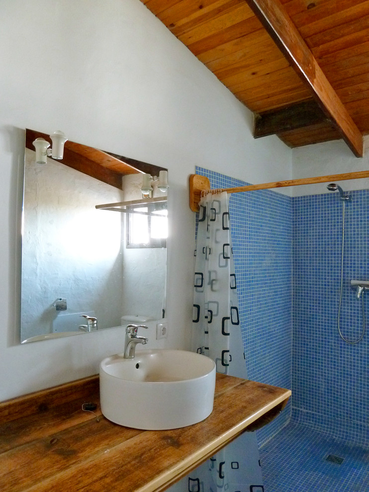 This is an example of a medium sized mediterranean shower room bathroom in Other with a walk-in shower, white walls, a vessel sink and wooden worktops.