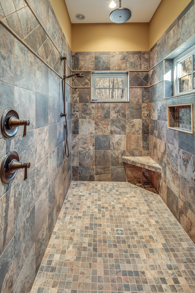 Design ideas for a medium sized rustic shower room bathroom with shaker cabinets, medium wood cabinets, an alcove shower, a one-piece toilet, beige tiles, beige walls, a submerged sink, multi-coloured floors, a hinged door and beige worktops.