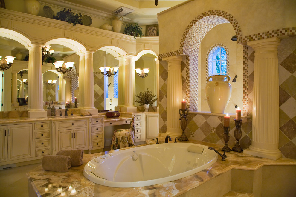 This is an example of a traditional bathroom in Miami with a built-in bath and mosaic tiles.