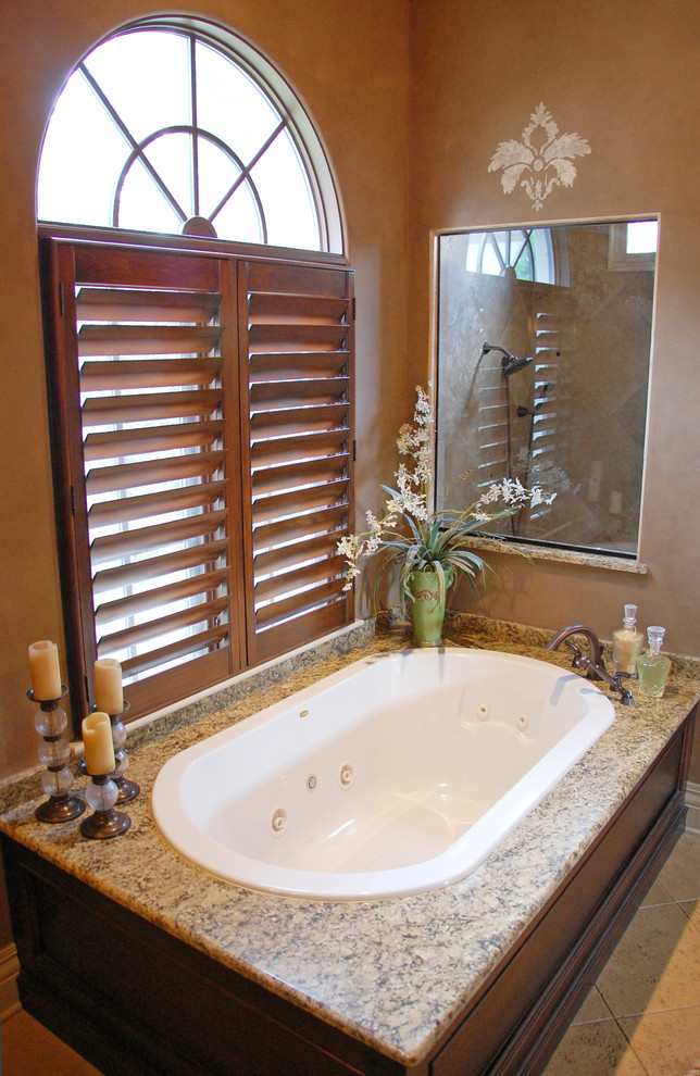 Bathroom - large mediterranean master beige tile and ceramic tile ceramic tile bathroom idea in Orlando with an undermount sink, a two-piece toilet, raised-panel cabinets, black cabinets, granite countertops and brown walls