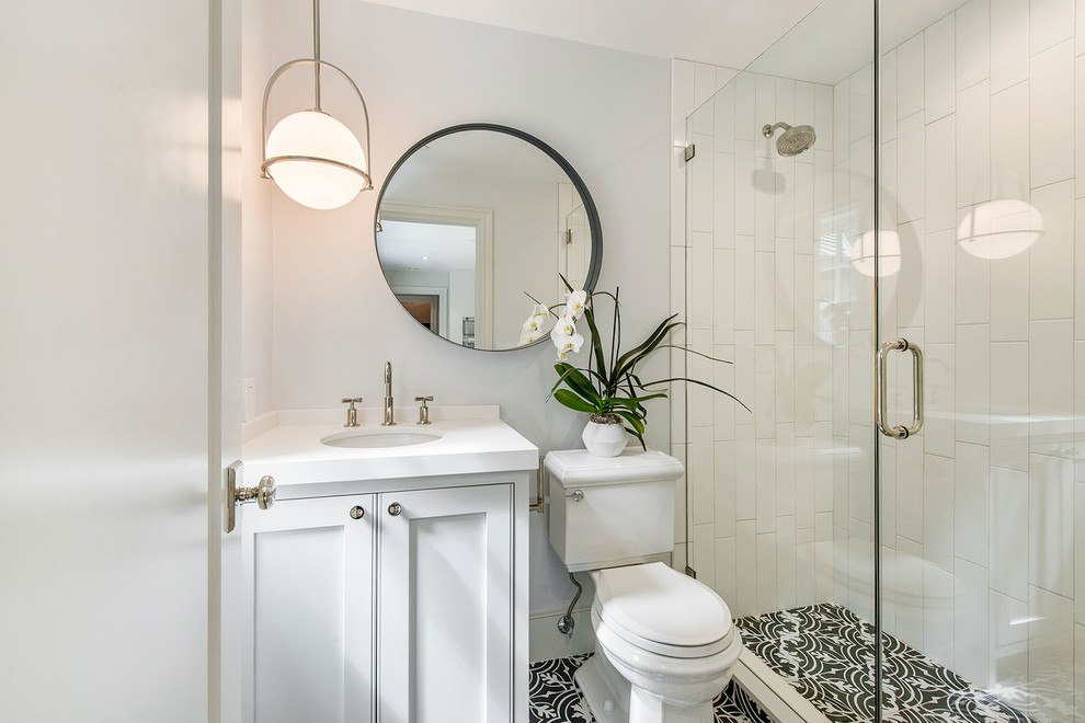 Corner shower - small contemporary 3/4 gray tile and subway tile cement tile floor and black floor corner shower idea in San Francisco with shaker cabinets, white cabinets, a one-piece toilet, gray walls, an undermount sink, marble countertops and a hinged shower door