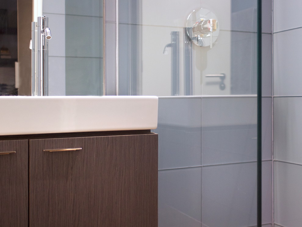 Design ideas for a small modern shower room bathroom with flat-panel cabinets, brown cabinets, a built-in shower, blue tiles, glass tiles, limestone flooring, engineered stone worktops, brown floors, an open shower and white worktops.