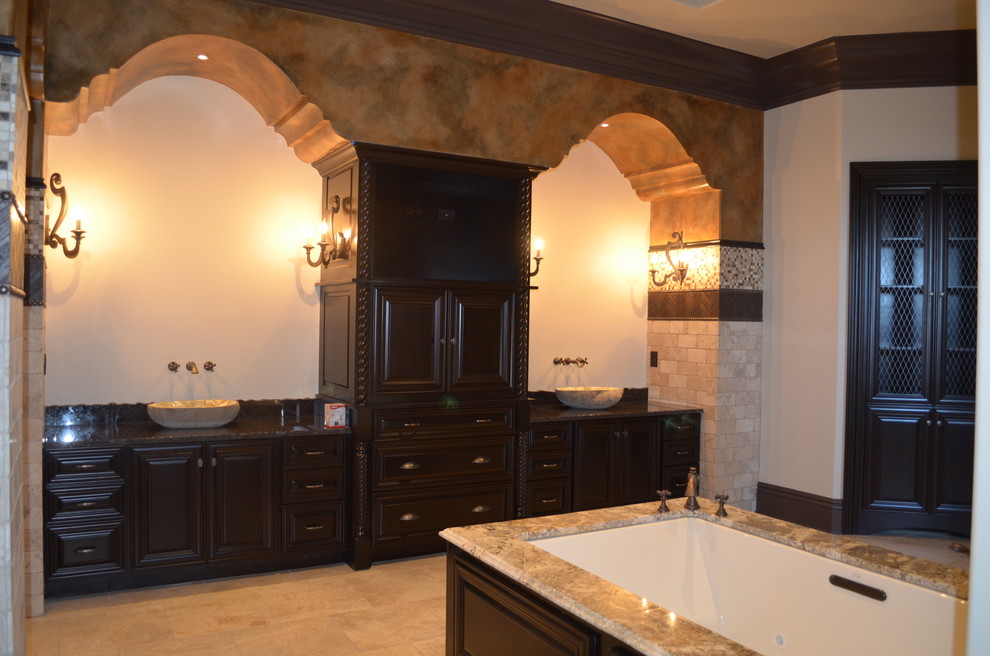 Inspiration for a huge mediterranean master brown tile and stone tile marble floor doorless shower remodel in Other with a vessel sink, raised-panel cabinets, blue cabinets, limestone countertops, an undermount tub and multicolored walls