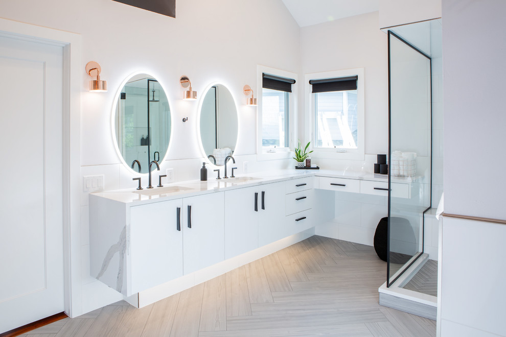 Inspiration for an expansive modern ensuite bathroom in Denver with flat-panel cabinets, white cabinets, a freestanding bath, a corner shower, a one-piece toilet, white tiles, ceramic tiles, white walls, porcelain flooring, a submerged sink, engineered stone worktops, grey floors, a hinged door and white worktops.