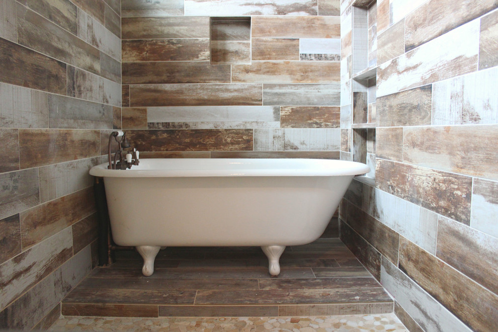 This is an example of a large rustic ensuite bathroom in Austin with a claw-foot bath and a shower/bath combination.