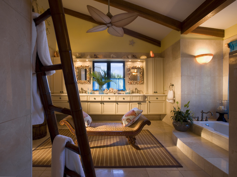 Island style beige tile drop-in bathtub photo in Miami with recessed-panel cabinets and beige cabinets