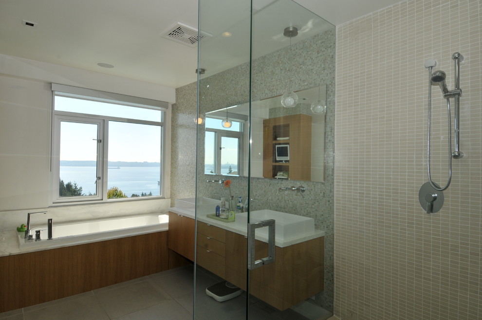 Design ideas for a medium sized contemporary ensuite bathroom in Vancouver with a vessel sink, flat-panel cabinets, medium wood cabinets, quartz worktops, a built-in bath, a corner shower, a one-piece toilet, multi-coloured tiles, glass tiles, multi-coloured walls and porcelain flooring.