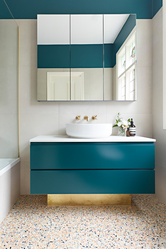 Example of a small trendy master beige tile and stone tile terrazzo floor and multicolored floor bathroom design in Melbourne with beige walls, a vessel sink, white countertops, green cabinets, a hinged shower door, furniture-like cabinets, a wall-mount toilet and quartz countertops