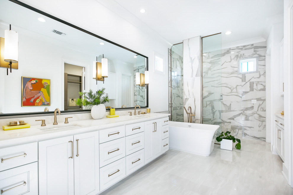 Example of a transitional master gray tile gray floor bathroom design in New Orleans with white cabinets, white walls, an undermount sink, white countertops and shaker cabinets
