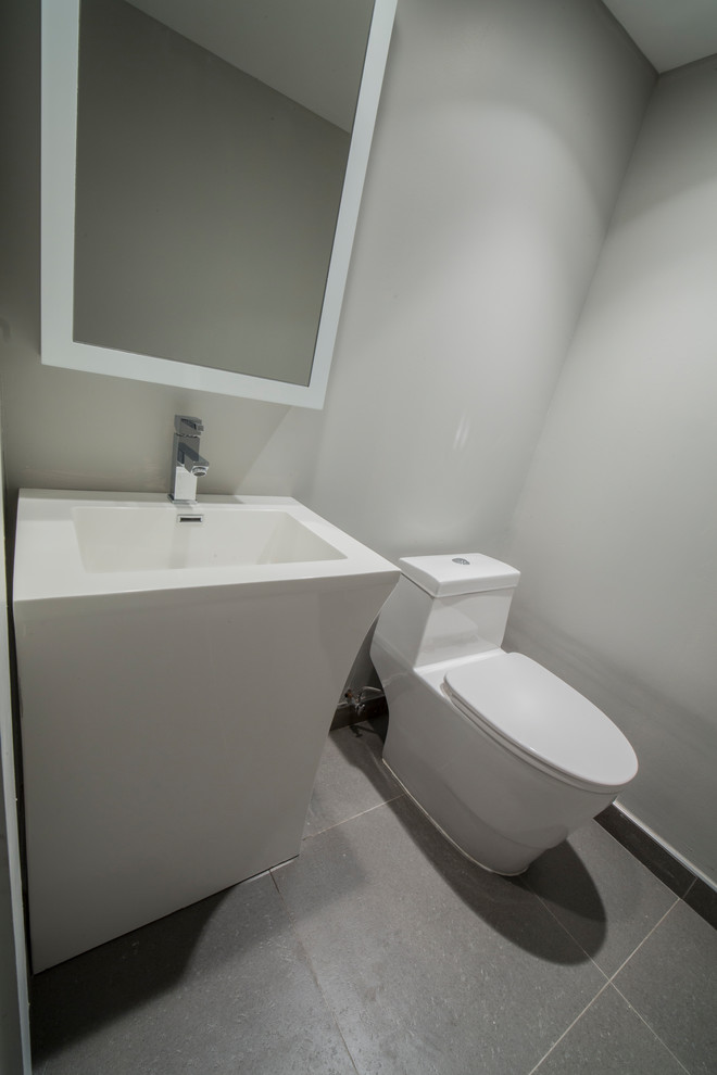 This is an example of a small modern shower room bathroom in New York with flat-panel cabinets, white cabinets, a one-piece toilet, white tiles, ceramic flooring, a pedestal sink, beige floors and white worktops.