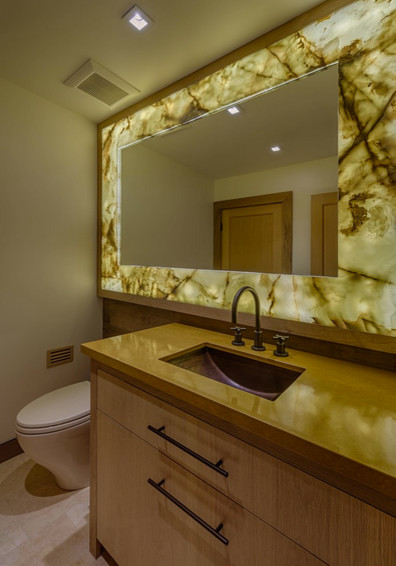 Medium sized contemporary ensuite bathroom in Sacramento with a submerged sink, light wood cabinets, beige walls, flat-panel cabinets, a one-piece toilet, porcelain flooring and solid surface worktops.