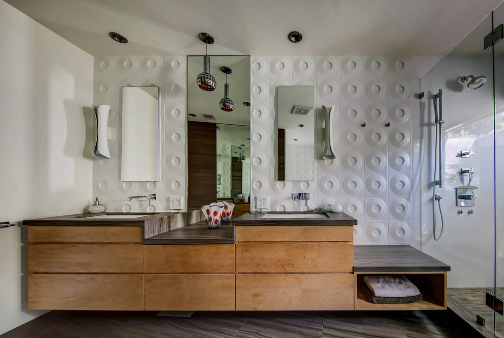 This is an example of a medium sized retro bathroom in Los Angeles with brown cabinets, an alcove shower, white walls and a hinged door.