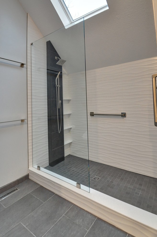 Photo of a medium sized contemporary ensuite bathroom in Other with shaker cabinets, grey cabinets, a double shower, a bidet, white tiles, porcelain tiles, grey walls, light hardwood flooring, a submerged sink, engineered stone worktops, beige floors, a hinged door and grey worktops.