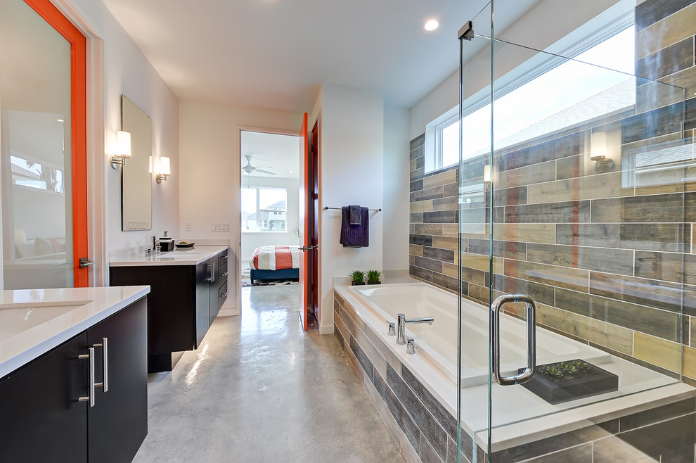 Inspiration for a mid-sized modern master multicolored tile and stone tile concrete floor bathroom remodel in Jacksonville with flat-panel cabinets, black cabinets, a two-piece toilet, white walls, an undermount sink, solid surface countertops and a hinged shower door