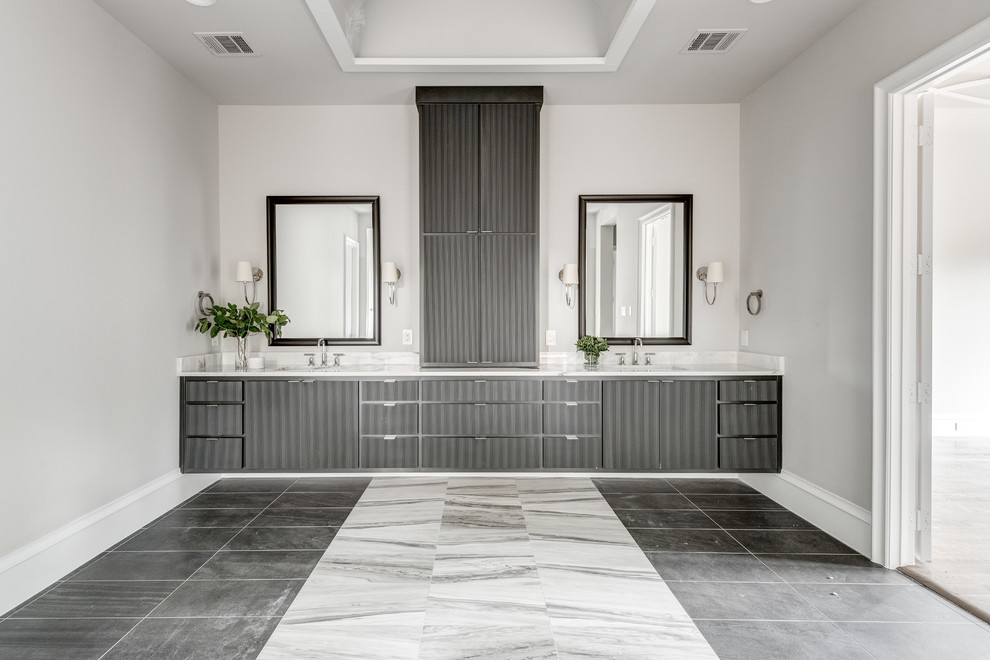 Inspiration for a large mediterranean ensuite bathroom in Dallas with shaker cabinets, white cabinets, a freestanding bath, a double shower, a two-piece toilet, black and white tiles, marble tiles, white walls, porcelain flooring, a submerged sink, marble worktops, grey floors, a hinged door and white worktops.