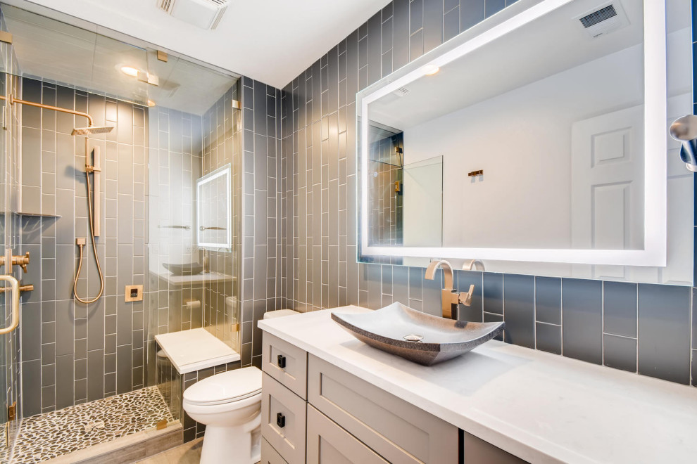 Bathroom - mid-sized transitional 3/4 gray tile and ceramic tile single-sink bathroom idea in Denver with shaker cabinets, white cabinets, quartz countertops, white countertops, a built-in vanity, gray walls, a vessel sink and a hinged shower door