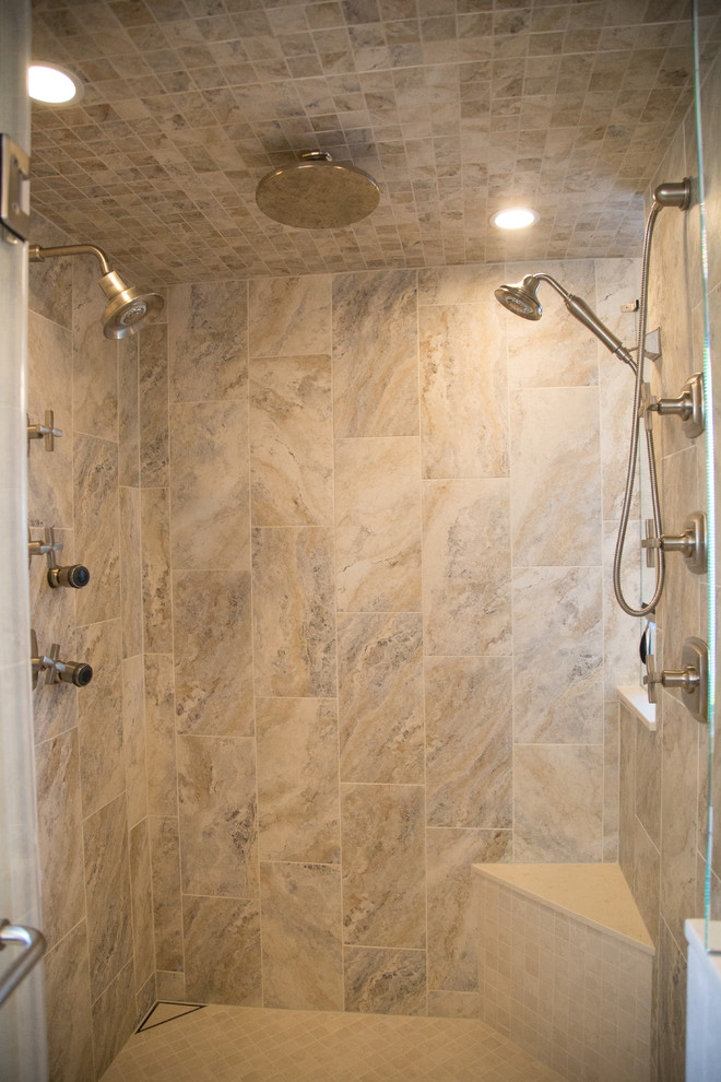 Inspiration for a large transitional master beige tile and porcelain tile porcelain tile double shower remodel in Denver with recessed-panel cabinets, brown cabinets, beige walls, an undermount sink and wood countertops