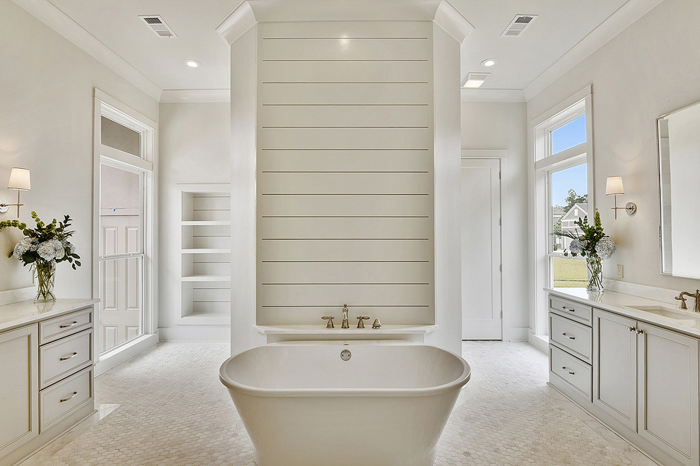 Freestanding bathtub - mid-sized transitional master white tile and mosaic tile dark wood floor freestanding bathtub idea in New Orleans with recessed-panel cabinets, gray cabinets, a two-piece toilet, white walls, a drop-in sink and marble countertops