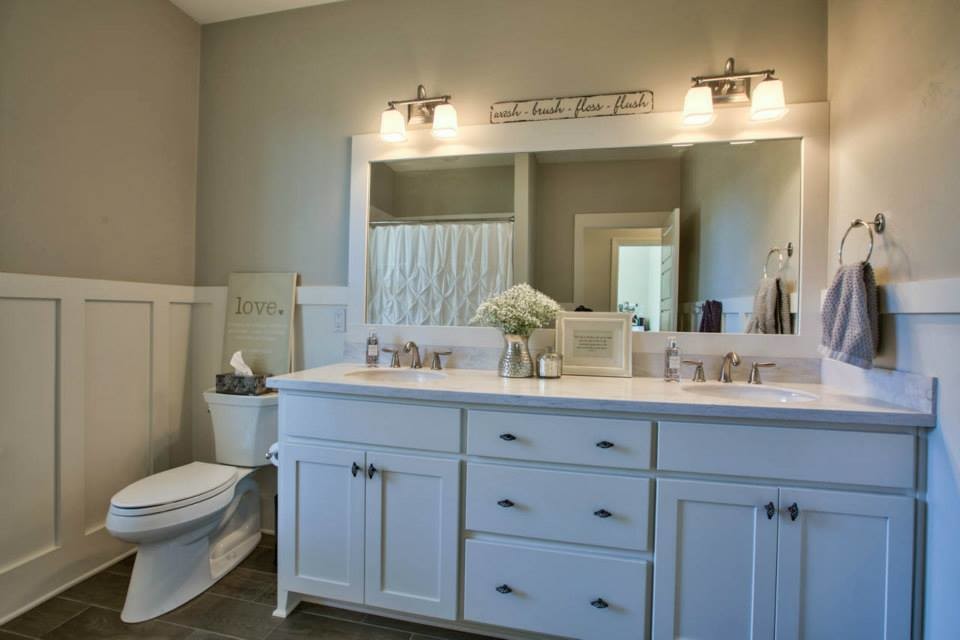 Medium sized nautical ensuite bathroom in Atlanta with shaker cabinets, white cabinets, a built-in bath, a corner shower, a two-piece toilet, stone tiles, white walls, vinyl flooring, a submerged sink and marble worktops.