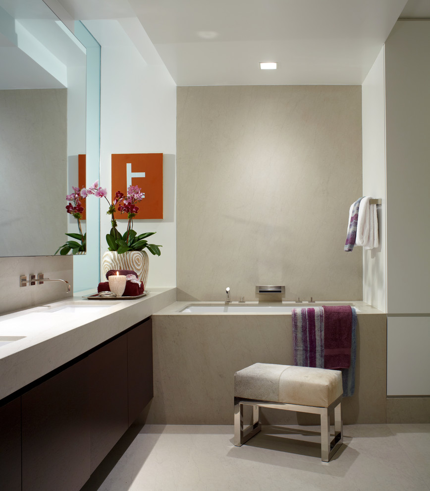 Inspiration for a large contemporary ensuite bathroom in New York with a japanese bath, flat-panel cabinets, dark wood cabinets, white walls, a submerged sink and solid surface worktops.