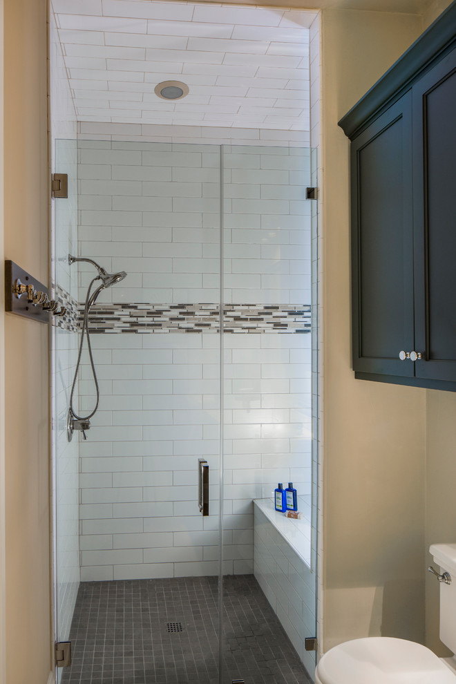 Photo of a medium sized traditional shower room bathroom in Austin with shaker cabinets, grey cabinets, a built-in shower, white tiles, metro tiles, beige walls, a two-piece toilet, mosaic tile flooring, grey floors and a hinged door.