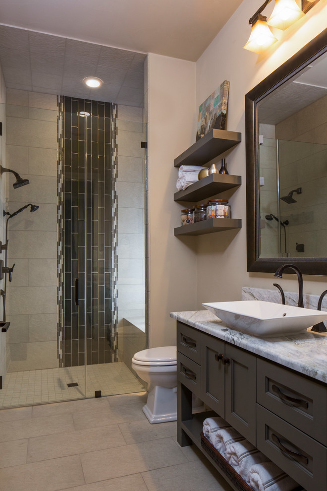 Inspiration for a mid-sized transitional 3/4 beige tile and porcelain tile porcelain tile and beige floor walk-in shower remodel in Austin with gray cabinets, beige walls, a vessel sink, quartzite countertops, recessed-panel cabinets and a hinged shower door