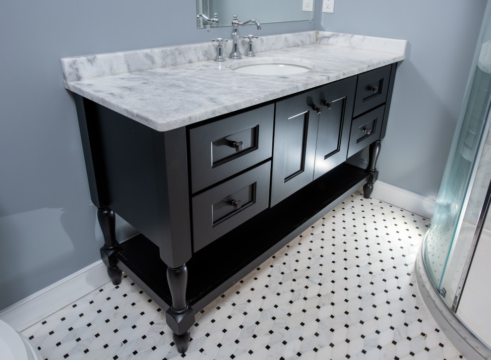 Example of a mid-sized classic multicolored tile and ceramic tile mosaic tile floor and multicolored floor bathroom design in New York with furniture-like cabinets, black cabinets, a two-piece toilet, blue walls, an undermount sink, marble countertops and multicolored countertops