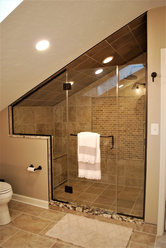 Design ideas for a large traditional ensuite bathroom in Cleveland with recessed-panel cabinets, beige cabinets, a freestanding bath, a two-piece toilet, orange tiles, porcelain tiles, beige walls, porcelain flooring, a submerged sink, granite worktops and beige floors.
