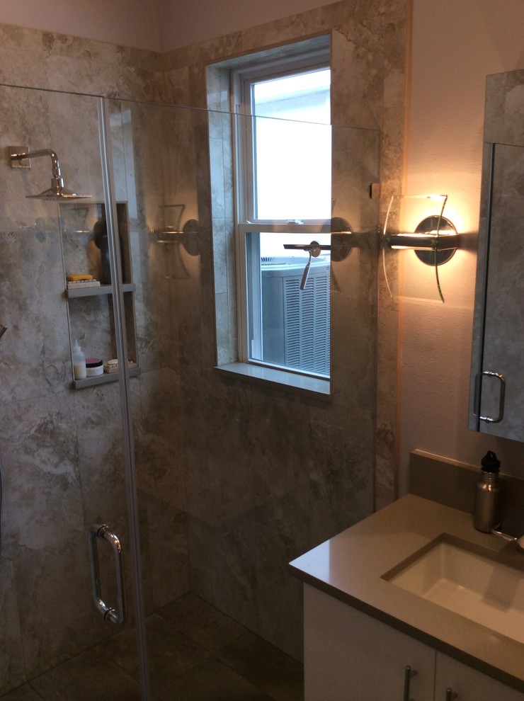Example of a mid-sized trendy beige tile and porcelain tile porcelain tile walk-in shower design in Tampa with an undermount sink, flat-panel cabinets, white cabinets, quartz countertops, a two-piece toilet and gray walls