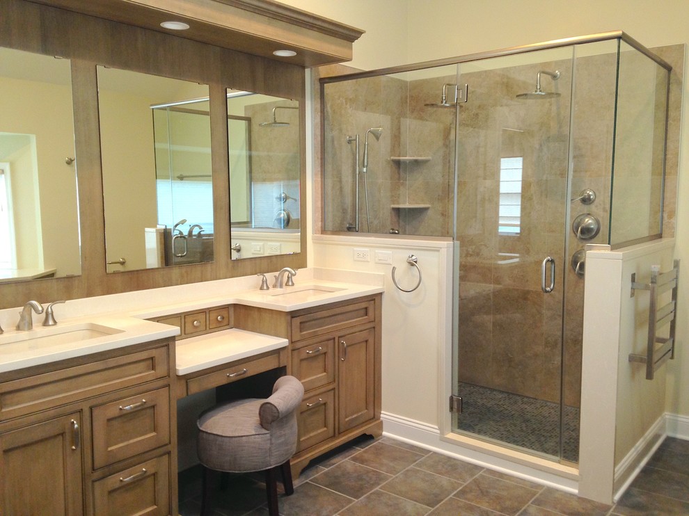 Example of a large classic master beige tile and porcelain tile porcelain tile corner shower design in New York with beaded inset cabinets, quartz countertops, medium tone wood cabinets, white walls and an undermount sink