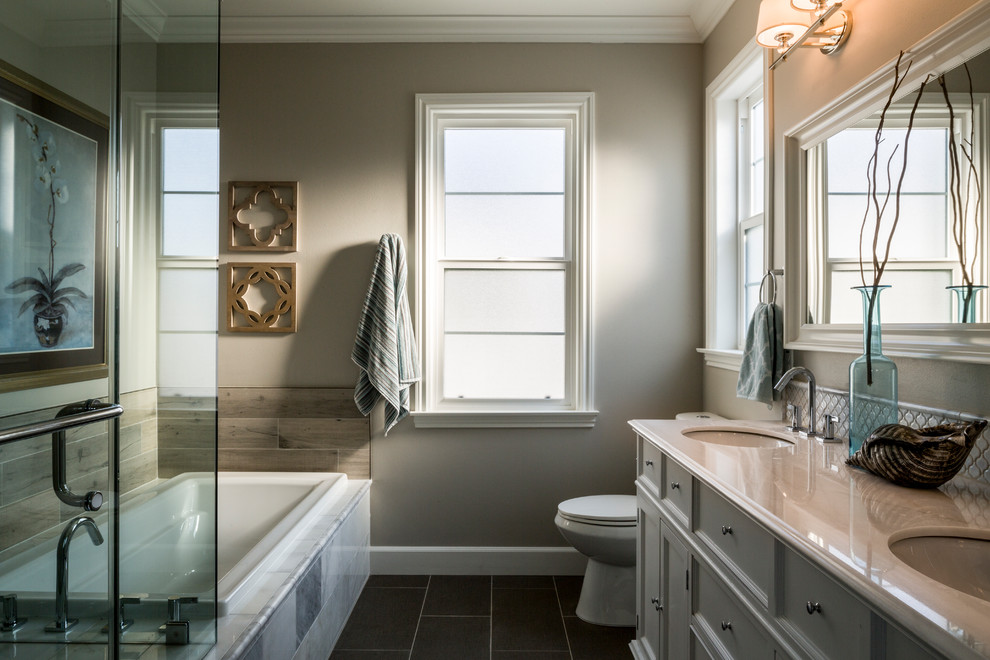Medium sized traditional shower room bathroom in Los Angeles with glass-front cabinets, white cabinets, a built-in bath, a corner shower, white tiles, ceramic tiles, beige walls, porcelain flooring, a submerged sink and engineered stone worktops.