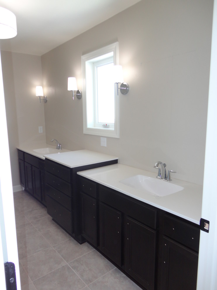 Inspiration for a medium sized traditional ensuite bathroom in Milwaukee with an integrated sink, recessed-panel cabinets, dark wood cabinets, engineered stone worktops, a walk-in shower, a two-piece toilet, grey tiles, ceramic tiles, beige walls and ceramic flooring.