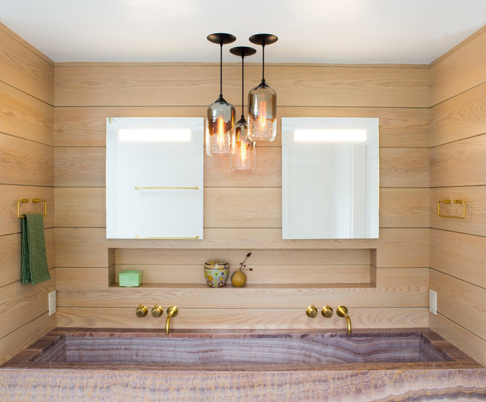 This is an example of a contemporary bathroom in New York with beige walls and a trough sink.