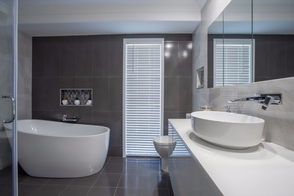 Imagen de cuarto de baño único actual con puertas de armario blancas y encimera de cuarzo compacto