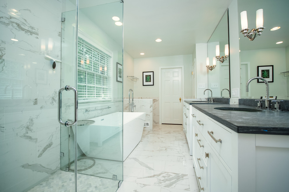 Inspiration for a large contemporary master white tile and marble tile marble floor and white floor bathroom remodel in Baltimore with flat-panel cabinets, white cabinets, a two-piece toilet, beige walls, an undermount sink, quartzite countertops, a hinged shower door and gray countertops