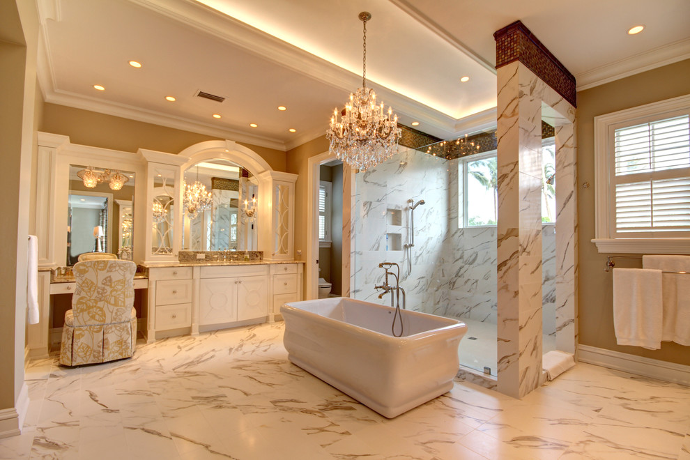 This is an example of a traditional ensuite bathroom in Miami with a freestanding bath and marble flooring.
