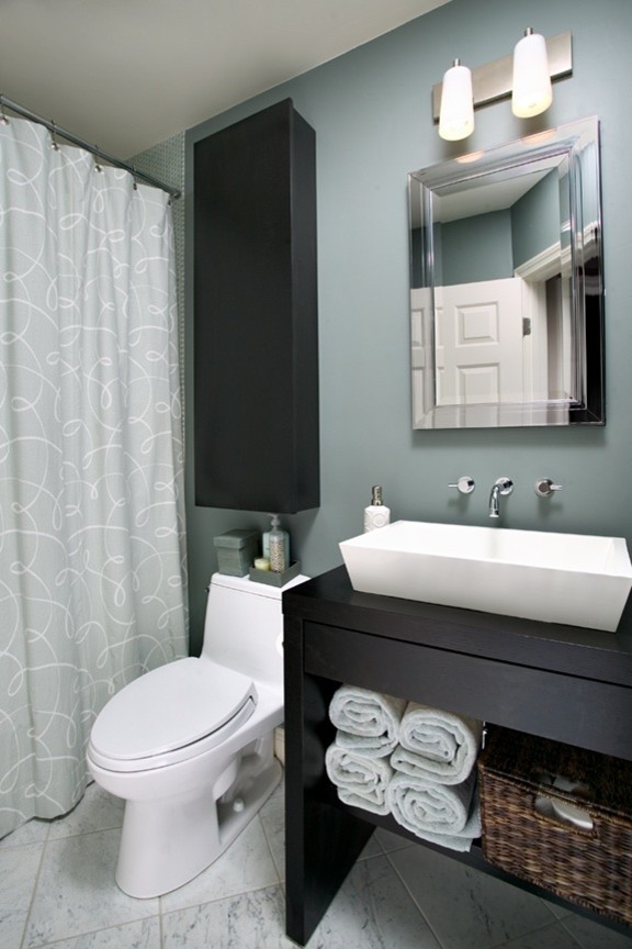 Foto di una stanza da bagno contemporanea con nessun'anta, ante nere, WC a due pezzi, pareti blu, pavimento in marmo e lavabo a bacinella