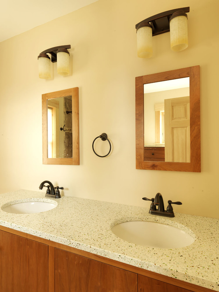Photo of a farmhouse bathroom in Burlington with flat-panel cabinets, dark wood cabinets, an alcove shower, beige walls and recycled glass worktops.