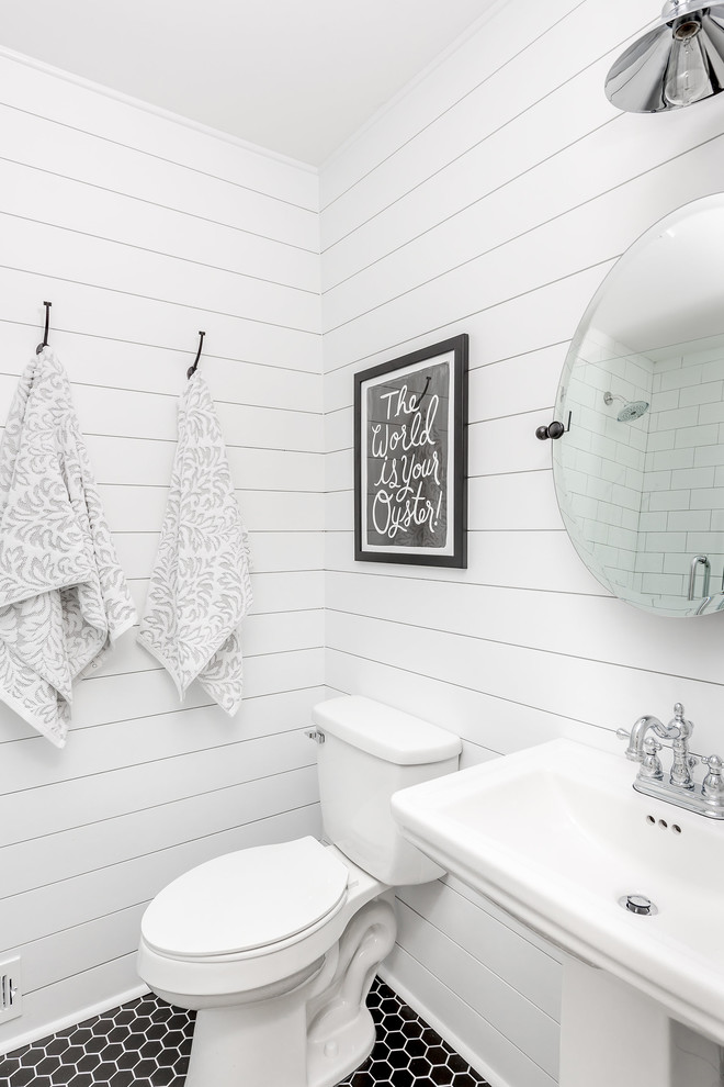 Corner shower - transitional 3/4 white tile and subway tile mosaic tile floor and black floor corner shower idea in Charlotte with a two-piece toilet, white walls, a pedestal sink and a hinged shower door