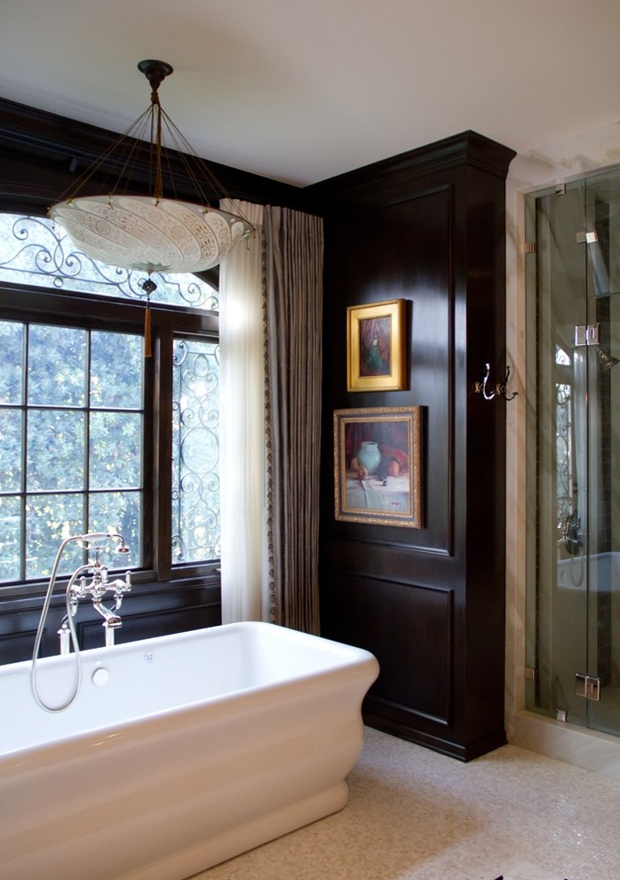 Example of a classic master mosaic tile floor freestanding bathtub design in Los Angeles with black walls