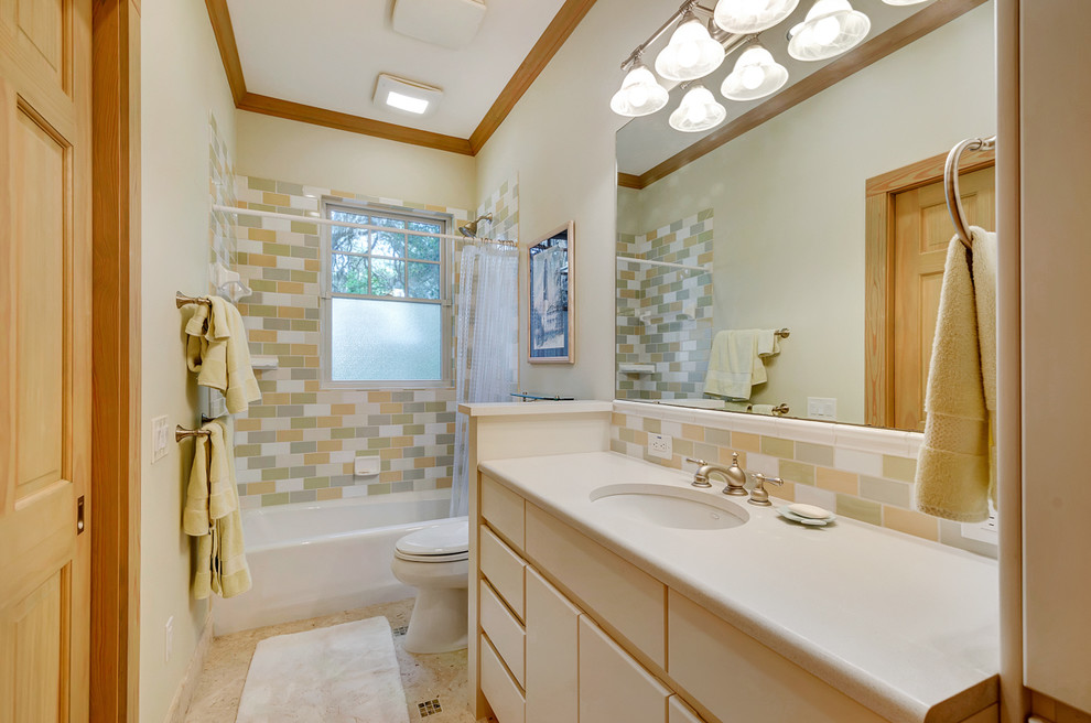 Inspiration for a medium sized contemporary ensuite bathroom in Miami with flat-panel cabinets, white cabinets, an alcove bath, a shower/bath combination, a one-piece toilet, multi-coloured tiles, glass tiles, white walls, marble flooring, a submerged sink, granite worktops, beige floors and a shower curtain.
