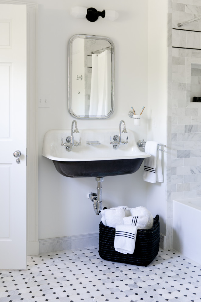 This is an example of a small classic family bathroom in New York with open cabinets, black cabinets, an alcove bath, a shower/bath combination, a two-piece toilet, white tiles, marble tiles, white walls, marble flooring, a trough sink, a shower curtain, white worktops, double sinks and a floating vanity unit.