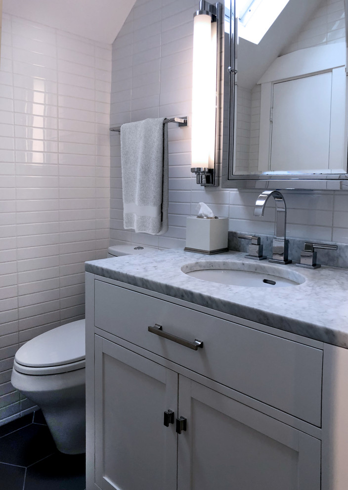 Small classic ensuite bathroom in Indianapolis with shaker cabinets, grey cabinets, an alcove shower, a one-piece toilet, white tiles, ceramic tiles, white walls, cement flooring, a submerged sink, marble worktops, grey floors, a hinged door, grey worktops, a single sink, a freestanding vanity unit and a vaulted ceiling.