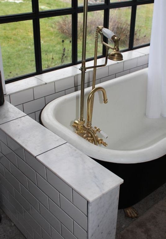 Inspiration for a mid-sized industrial 3/4 white tile and subway tile ceramic tile and black floor bathroom remodel in Seattle with white walls, open cabinets, a console sink, marble countertops and a two-piece toilet