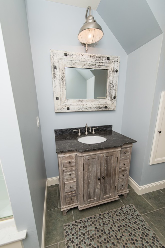 Tub/shower combo - mid-sized coastal 3/4 porcelain tile tub/shower combo idea in New York with an undermount sink, furniture-like cabinets, light wood cabinets, marble countertops, a one-piece toilet and blue walls