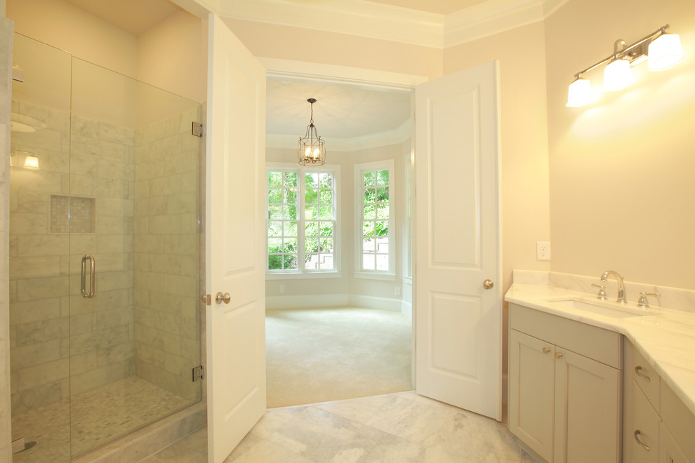 Large country ensuite bathroom in Atlanta with recessed-panel cabinets, grey cabinets, marble worktops, a corner bath and marble flooring.