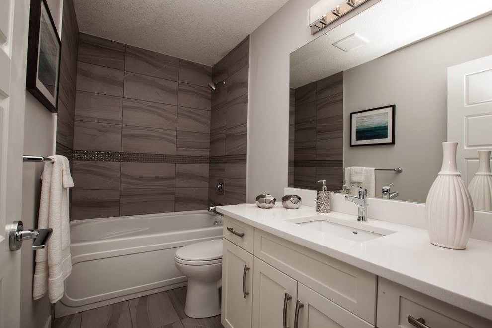 Inspiration for a mid-sized contemporary kids' gray tile and porcelain tile porcelain tile bathroom remodel in Edmonton with shaker cabinets, white cabinets, a one-piece toilet, gray walls, an undermount sink and quartz countertops