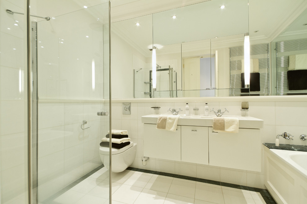 Photo of a contemporary bathroom in London with a wall mounted toilet and a dado rail.