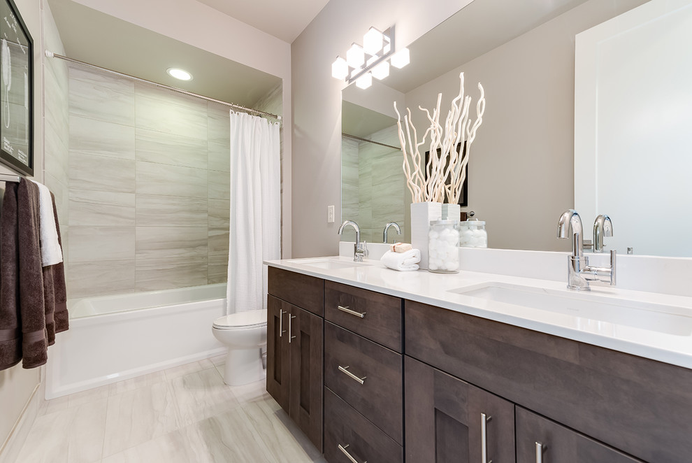 Large transitional beige tile and porcelain tile porcelain tile bathroom photo in Seattle with shaker cabinets, dark wood cabinets, a two-piece toilet, white walls, an undermount sink and solid surface countertops