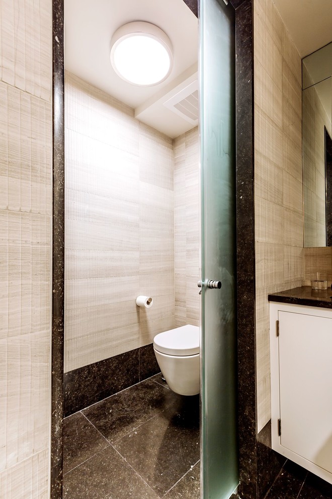 Inspiration for a large contemporary ensuite bathroom in New York with flat-panel cabinets, white cabinets, an alcove shower, a wall mounted toilet, beige tiles, ceramic tiles, beige walls, ceramic flooring, a submerged sink, granite worktops, black floors, a hinged door, black worktops, an enclosed toilet, a single sink, a floating vanity unit and a coffered ceiling.